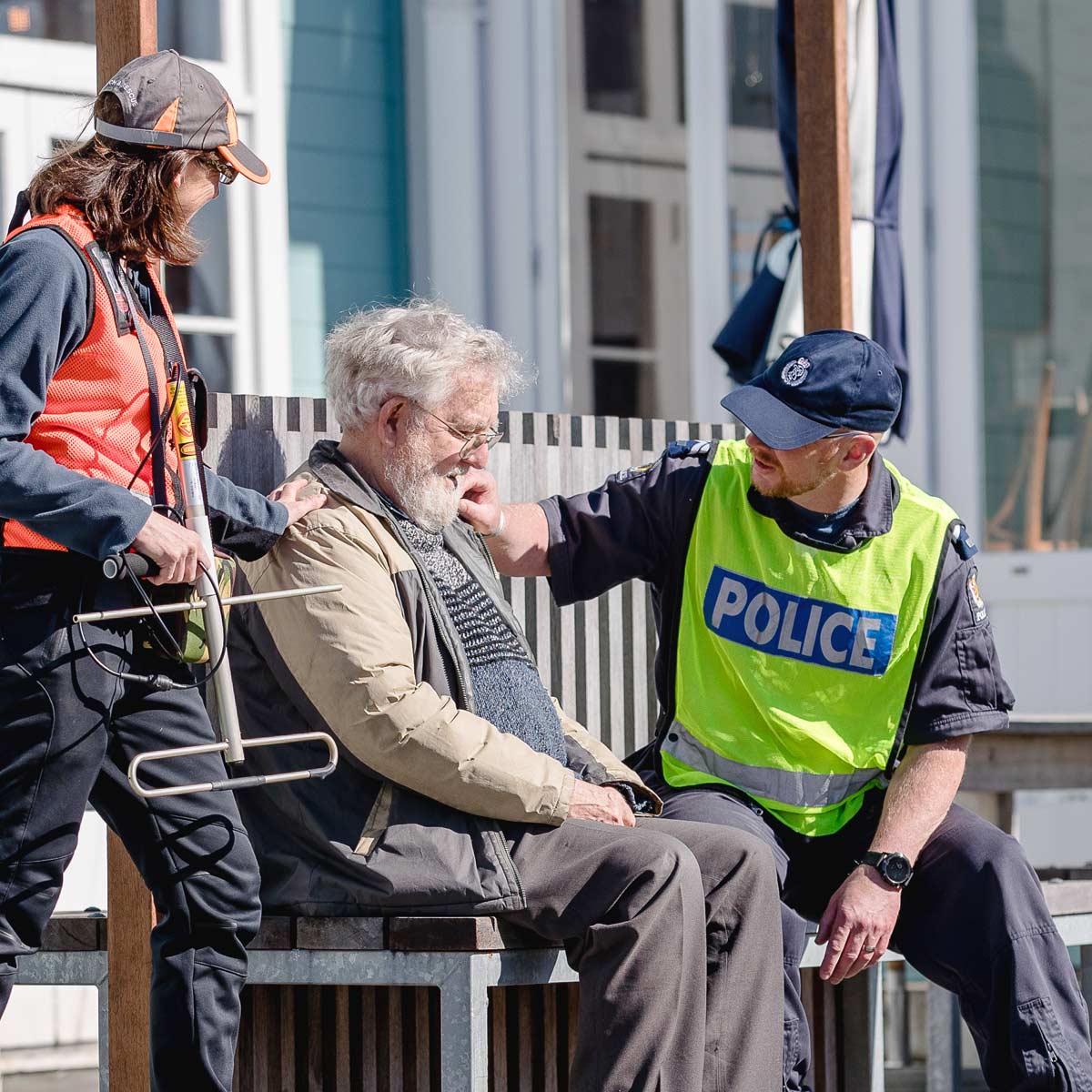 Police and volunteers with older man